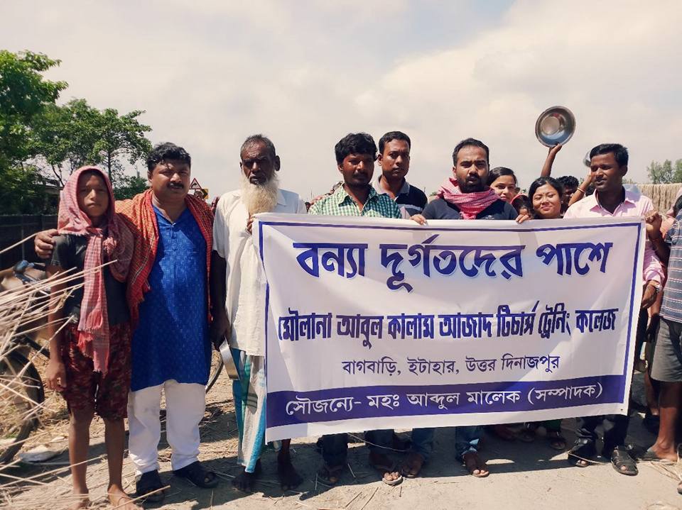 Volunteers with a flood relief banner
